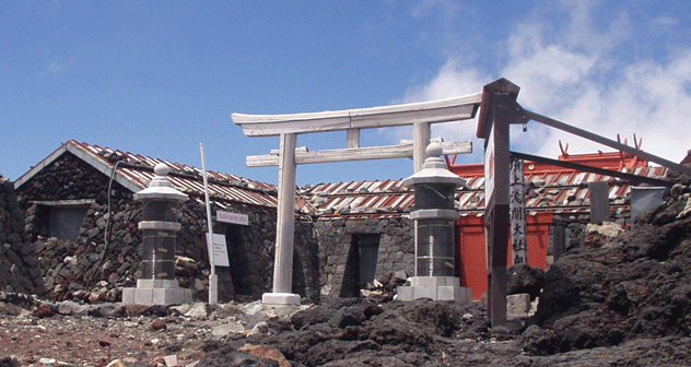 Post office and shrine at the top of the trail. Crater is behind. The true summit is behind the post office and left around the crater rim.
